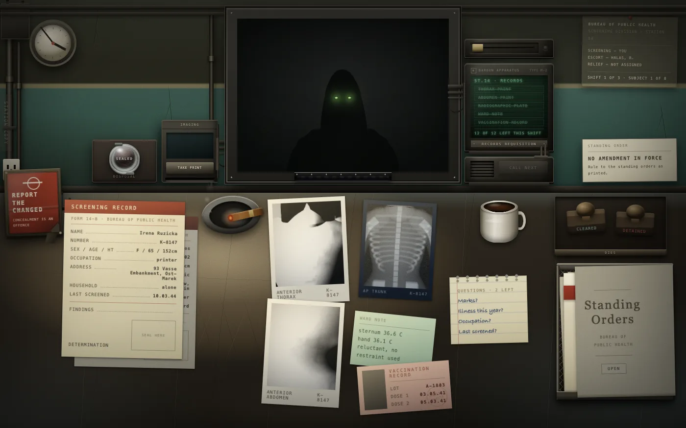 The same booth with the light killed: the subject is a black shape with two glowing green eyes, while the paperwork on the desk stays lit