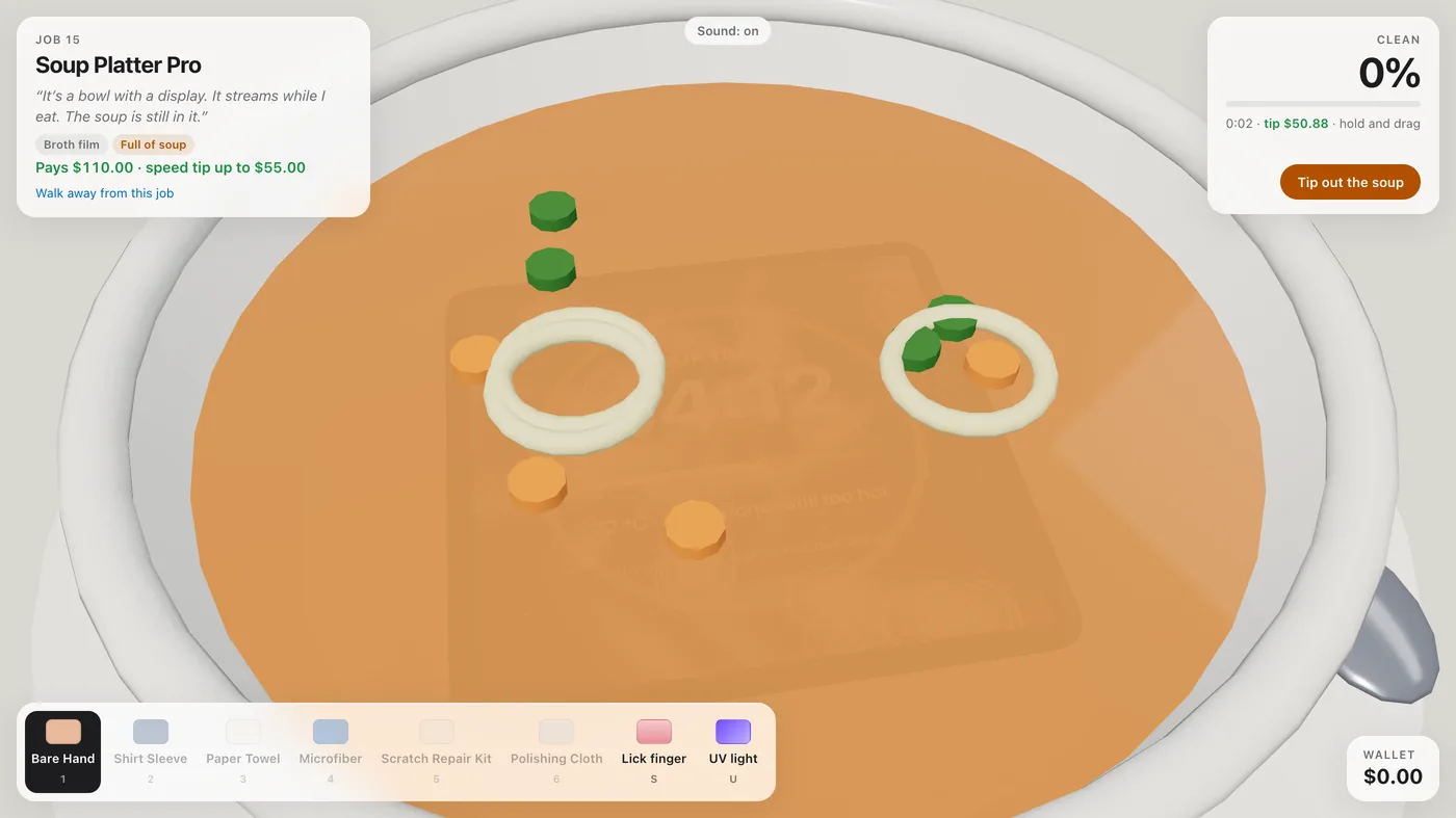 A wide ceramic bowl full of orange soup with peas, carrot slices and noodle rings floating in it, a screen faintly visible underneath